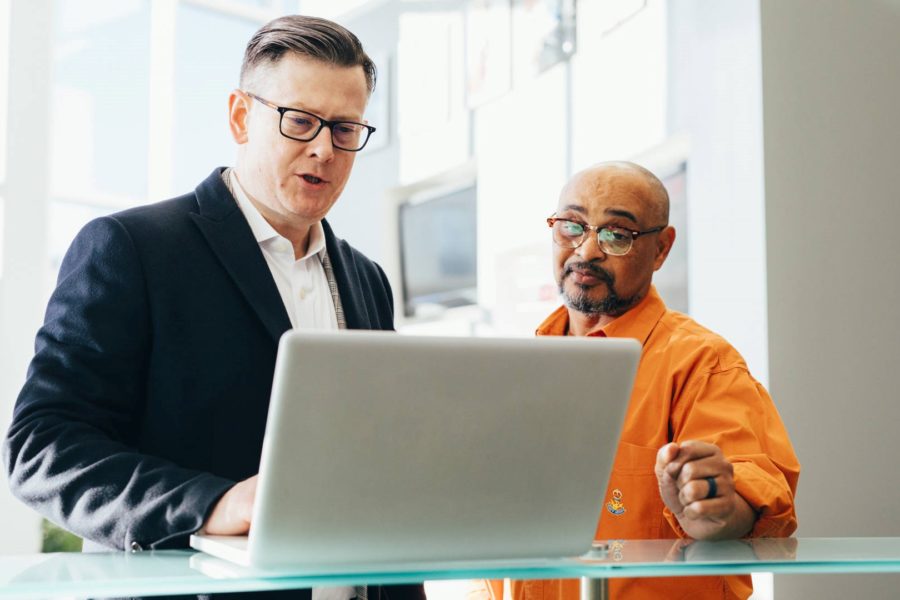 Businesspeople at computer, revising business growth strategy