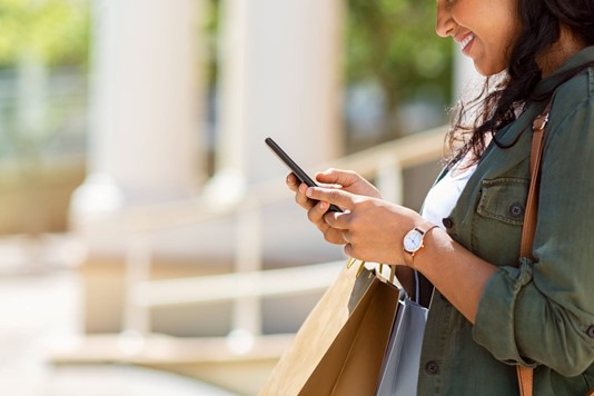 Woman uses phone to shop online