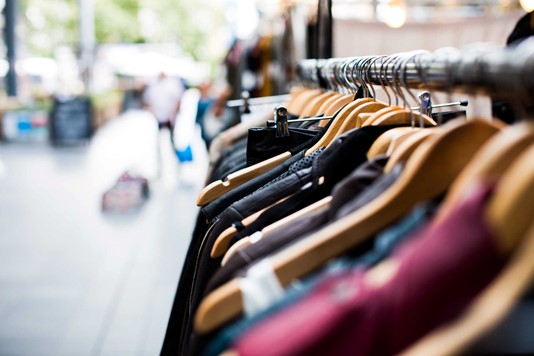 Name brand clothing on a retail rack