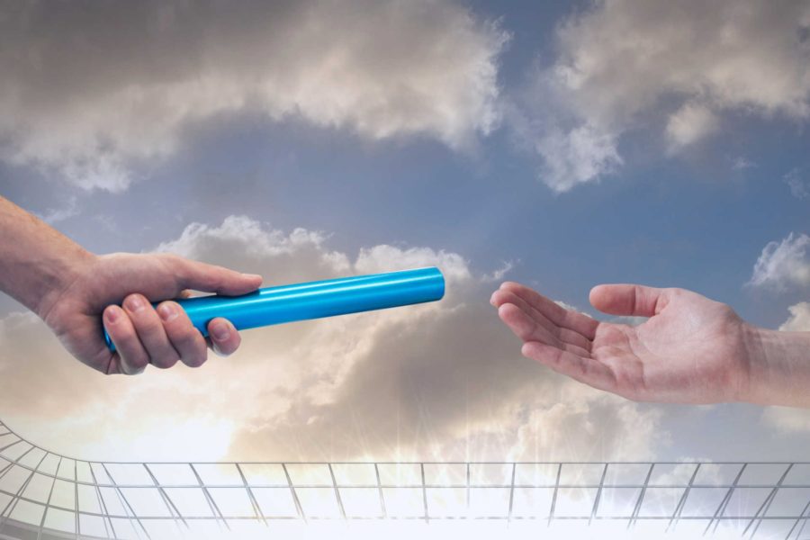 One hand passes baton to another hand