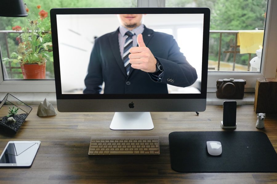 A laptop set up at home with a Zoom call happening onscreen