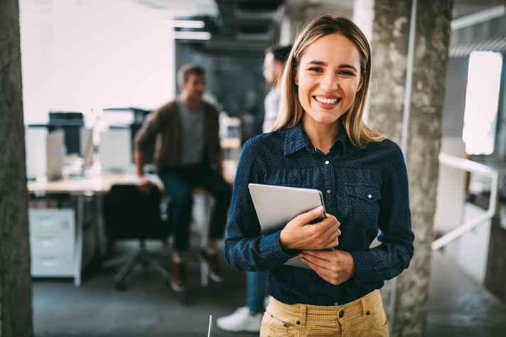 A happy employee at a modern company that supports wellness at work