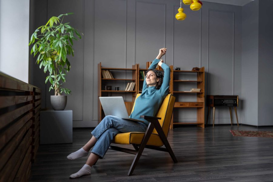 Young woman with laptop enjoying better work life balance